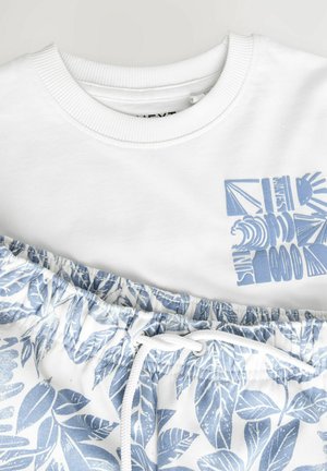 White sweatshirt with a light blue graphic, paired with white shorts featuring a blue leaf pattern and drawstring. Soft cotton material.
