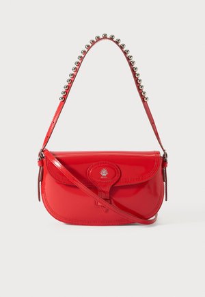 Red patent leather shoulder bag with rounded shape, decorative silver ball accents on the strap, and a central logoed clasp closure.