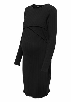 Mustakil ribbed-maternaalimekko pitkillä hihoilla, jossa on drapattu yllätystekstiili rinnassa. Valmistettu pehmeästä ja joustavasta materiaalista.