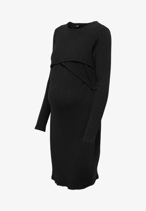 Czarna, prążkowana sukienka ciążowa z długimi rękawami, z drapowanym nadłużeniem w okolicy biustu. Wykonana z miękkiego, elastycznego materiału.