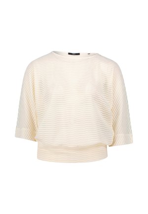 Cream-colored short-sleeve top made from textured fabric with a subtle zig-zag pattern. Features a round neckline and cropped fit.