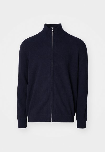 Ναυτικό φούτερ με φερμουάρ και ψηλό γιακά, υφασμάτινη επιφάνεια με ραβδώσεις, μακριά μανίκια και μεταλλικό κλείσιμο με φερμουάρ.