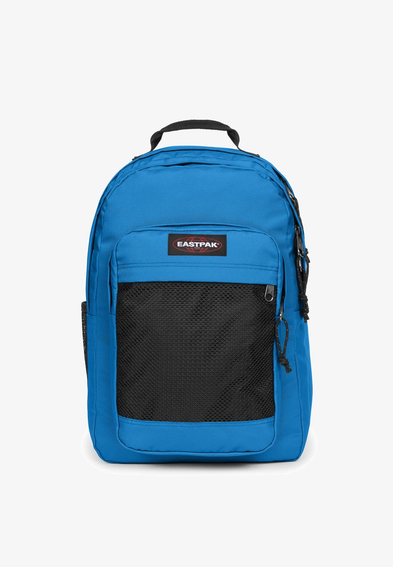 Sac à dos bleu en tissu durable avec une poche avant en maille noire, des bretelles réglables et une poignée supérieure pour le transport.