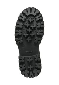 Semelle de chaussure en caoutchouc noir avec un motif de semelle antidérapant composé de crampons en forme d'étoile et de trous de drainage ; logo de la marque en relief visible.