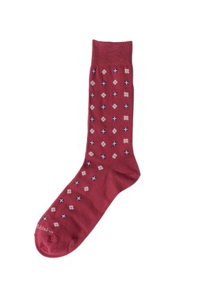 Roter Socken mit kleinen weißen und marineblauen Blumenmustern, gleichmäßig über den Stoff verteilt.