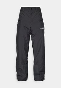 Pantalones impermeables negros con un ajuste relajado, cintura elástica, bolsillos con cremallera y un logo en el lateral. Fabricados con material durable y ligero.