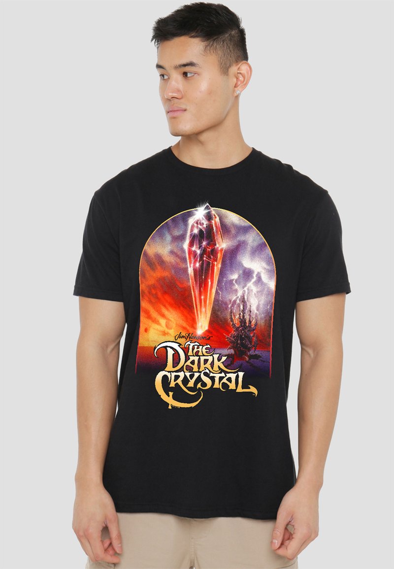 Black cotton t-shirt featuring a colorful graphic of a crystal and landscape from "The Dark Crystal," with stylized text and artistic details.