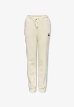 Svedbukser i cremefarve med elastisk taljebånd og snøre, sidelommer, manchetter ved anklerne og en lille logopatch på højre lår.