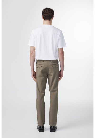 Weißes Rundhalsausschnitt-T-Shirt und olivgrüne Hose mit Gesäßtaschen. Die Hose hat eine gerade Passform und besteht aus einem glatten Stoff.