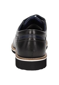 Zwarte leren schoen met een gladde bovenkant, contrasterende marineblauwe accenten en een gevoerde binnenkant. Heeft een rubberen zool met witte en tan details.