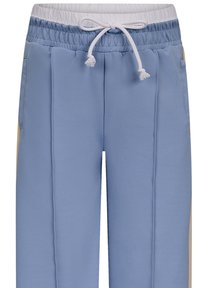 Helle blaue Sweatpants mit elastischem Bund, weißem Kordelzug und kontrastierenden beigefarbenen Seitenteilen. Glattes synthetisches Material, gerade Passform.