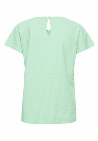 Haut court à manches courtes de couleur vert clair en tissu texturé, présentant un détail de dos en forme de clef avec une fermeture à bouton unique.