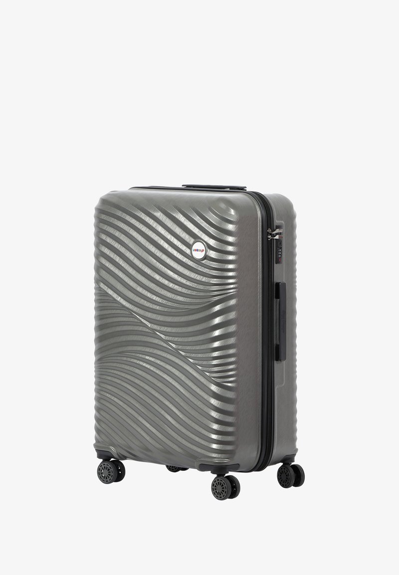 Hard-shell suitcase in a textured wave pattern, metallic gray finish. Features double wheels and a combination lock on the side.