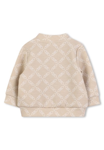 Sweatshirt beige avec un motif en diamant blanc. Comprend un col et un ourlet élastique. Le tissu a une texture lisse et douce. Manches longues.