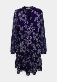 Vestido floral azul-marinho feito de um tecido leve, com mangas longas, um decote em V e uma barra godê com padrões florais brancos.