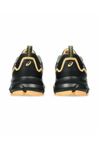 Black and olive green athletic shoes with a padded black heel, yellow accents, and a textured sole for grip, featuring a pull tab at the rear.