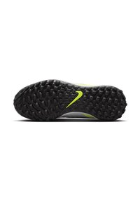 Semelle de crampons de football Nike avec un caoutchouc texturé noir, accentué de jaune, et d'une forme arrondie conçue pour offrir une traction sur diverses surfaces.