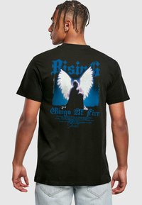 Black cotton t-shirt featuring a blue and white graphic design of angel wings and text on the back, with a relaxed fit and short sleeves.