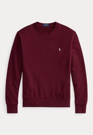 Felpa bordeaux in cotone morbido, con colletto a girocollo e maniche lunghe. Piccolo logo ricamato sul petto, polsini e orlo a costine.