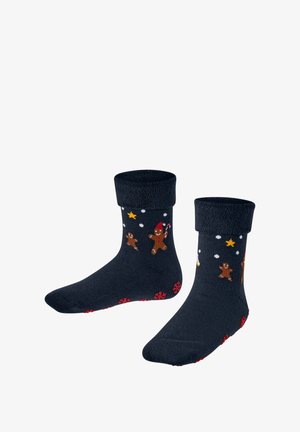 Marineblaue Socken mit einem gerollten Bündchen, die Lebkuchenmänner, Zuckerstangen und Sterne in vielen Farben zeigen, mit einem strukturierten roten Schneeflockenmuster an der Sohle.