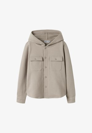 Light beige hooded shirt jacket, textured fabric, two chest pockets with flaps, center button closure, and long sleeves.
