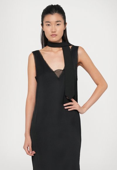 Black sleeveless dress with lace trim, featuring a wraparound fabric detail at the neck. Soft texture and a straight silhouette.