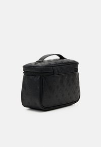 Black leather bag with embossed floral pattern, rounded shape, zippered top, and a small handle. Smooth texture, compact design.