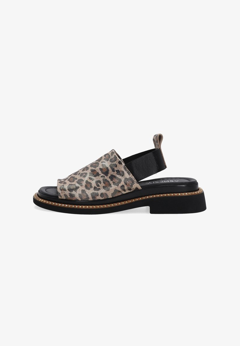 Leopard print slingback sandal with a flat black sole, textured fabric upper, and contrasting gold trim detailing along the sole edge.