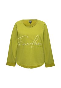Sweatshirt vert à manches longues avec un col rond, comportant une broderie blanche "Freedom" et un ourlet arrondi. Tissu doux avec des poignets côtelés.