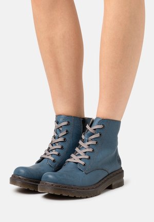 Blue leather ankle boots with gray laces, padded collar, sturdy rubber sole, and side zipper. Smooth texture and contrasting stitching details.