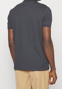 Kortärmad polo skjorta i mörkgrå bomullstyg, med en klassisk krage och snyggt avslutade sömmar utan utsmyckningar.