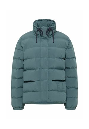 Green puffer jacket with high neck, drawstring, and quilted design. Features two front pockets and a subtle logo on the lower side.
