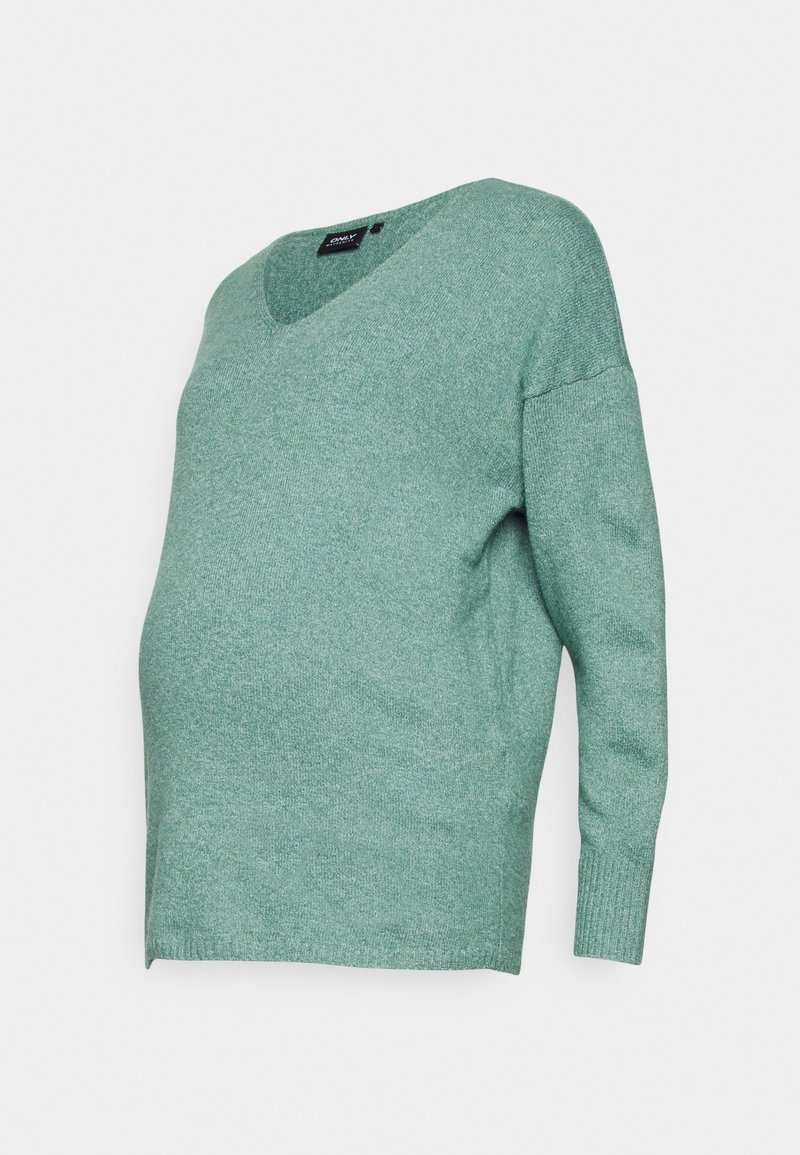 Pull maternité vert clair à manches longues et col en V, conçu pour s'adapter à un ventre qui s'arrondit.