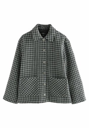 Giacca grigia e nera a motivo houndstooth con colletto, bottoni frontali e due grandi tasche anteriori. Realizzata in tessuto testurizzato.