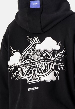 Black hoodie featuring a large white graphic design with clouds and lightning, text reading "Well you play with the cards you hold," and brand logo.
