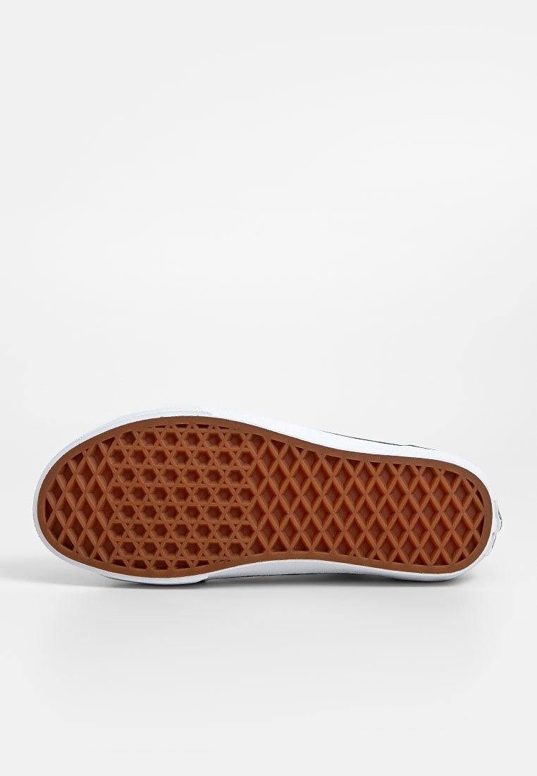 Suela de zapato de goma con textura en panal, de color marrón y borde blanco alrededor. Diseñada para ofrecer agarre y tracción.