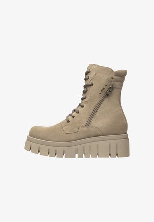Beige suede ankle boot with a chunky platform sole, lace-up front and side zipper for easy wear. Round toe and ribbed sole detail.