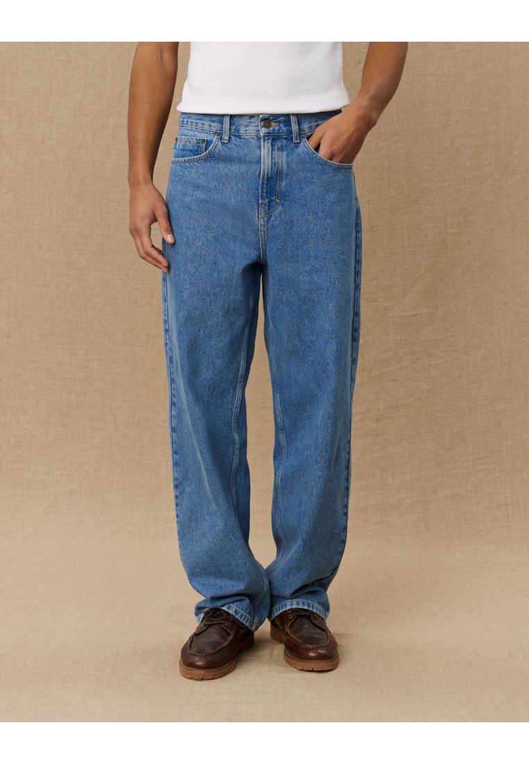 Light blue denim jeans with a relaxed fit, featuring five pockets and a mid-rise waist. The fabric has a slightly faded texture.