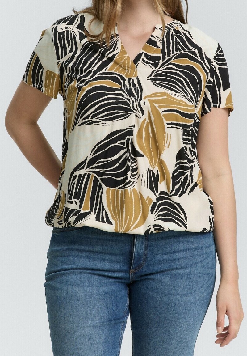 Kortærmet bluse med en cremefarvet bund og mønster af sorte og sennepsgule blade. V-hals design med løs pasform. Blødt stof.