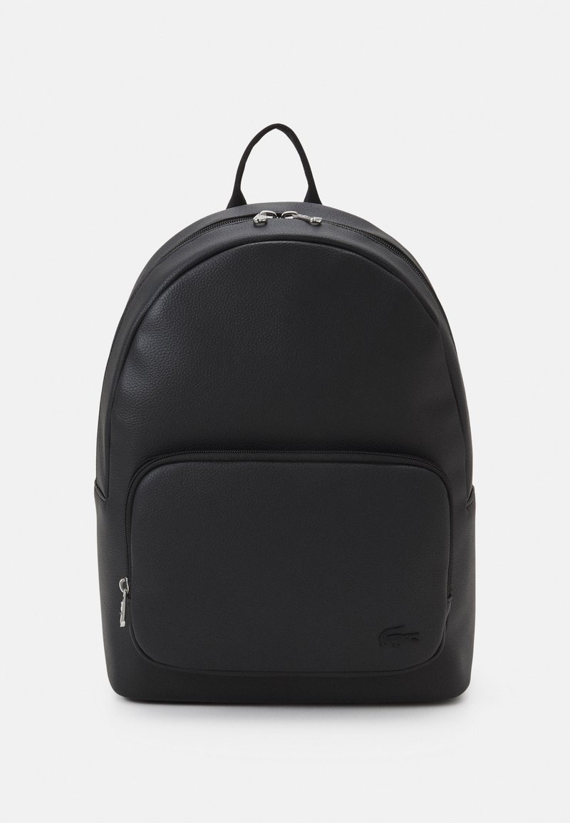 Black leather backpack with rounded shape, top handle, front zip pocket, and subtle logo; features smooth texture and silver hardware accents.
