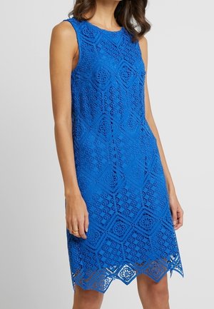 Sleeveless bright blue lace dress with geometric and floral patterns, knee-length hem with diamond-shaped cutouts.
