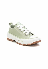 Zapatillas de lona verde claro con suela de goma blanca, que presentan cordones anchos, ojales de metal y una suela de goma texturizada.