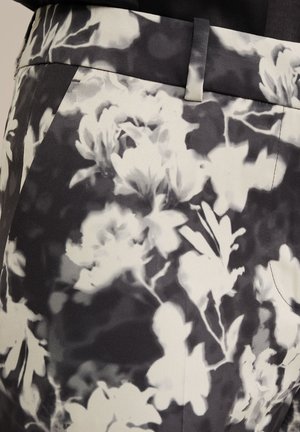 Tissu floral en noir et blanc avec une texture lisse. Dispose d'une taille ajustée et de poches latérales. Convient pour une tenue formelle ou décontractée.