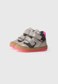 Children's sneakers with gray metallic upper, black mesh sides, pink accents, Velcro straps, and rubber sole featuring pink and brown hues.