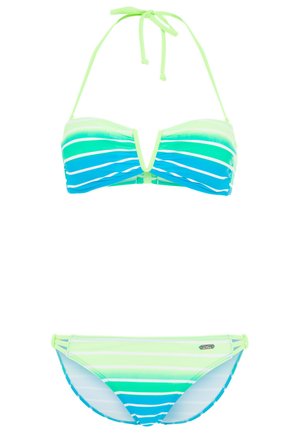 Woman wearing green, blue, and white striped halter bikini with cutout detailing on the top and side straps on the bottoms.