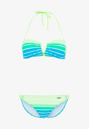 Woman wearing green, blue, and white striped halter bikini with cutout detailing on the top and side straps on the bottoms.