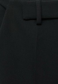 Crne hlače izrađene od mekog materijala, s glatkom teksturom, prilagođenim pojasom i suptilnim šavnim detaljima duž šavova.