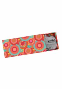 Kosmetisk förpackningslåda med en livlig design med färgglada cirklar i rosa, orange och teal; inkluderar en grå produktpåse inuti.