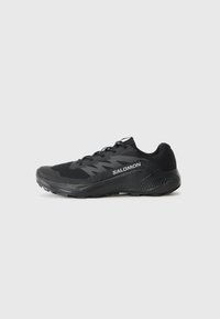 Black athletic shoe with a textured, breathable upper, reinforced toe cap, and cushioned sole. Features laces and a logo on the side.