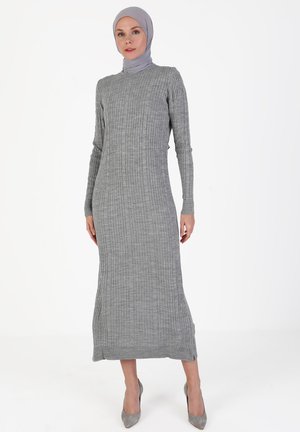 Gray ribbed dress with long sleeves and a high neckline, featuring a fitted silhouette and side slits at the hem, made of soft knit fabric.